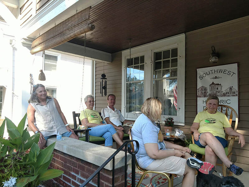 a group of 5 sitting on a porch in historic troy ohio