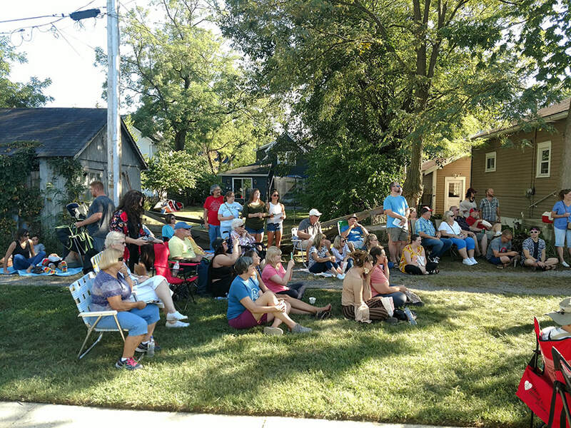 a group of people sitting in various chairs enjoying music in troy ohio